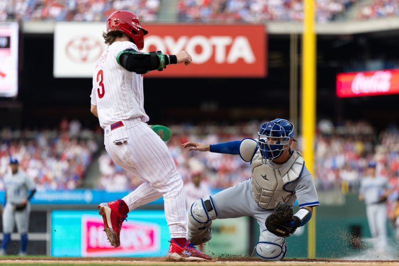 Aug 5, 2023; Philadelphia, Pennsylvania, USA; Kansas City Royals catcher Freddy Fermin (34) tags out Philadelphia Phillies designated hitter Bryce Harper (3) at home plate during the first inning at Citizens Bank Park. Mandatory Credit: Bill Streicher-USA TODAY Sports