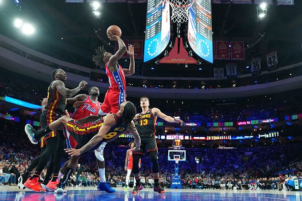 PHILADELPHIA, PENNSYLVANIA - DECEMBER 8: Tyrese Maxey #0 of the Philadelphia 76ers shoots the ball against Patty Mills #8 of the Atlanta Hawks in the fourth quarter at the Wells Fargo Center on December 8, 2023 in Philadelphia, Pennsylvania. The 76ers defeated the Hawks 125-114. NOTE TO USER: User expressly acknowledges and agrees that, by downloading and or using this photograph, User is consenting to the terms and conditions of the Getty Images License Agreement. (Photo by Mitchell Leff/Getty Images)