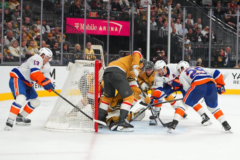 Nov 13, 2025; Las Vegas, Nevada, USA; Vegas Golden Knights left wing Ivan Barbashev (49) keeps the puck out of the net with his skate as New York Islanders center Mathew Barzal (13) looks to tap it over the line during an overtime period at T-Mobile Arena. Mandatory Credit: Stephen R. Sylvanie-Imagn Images