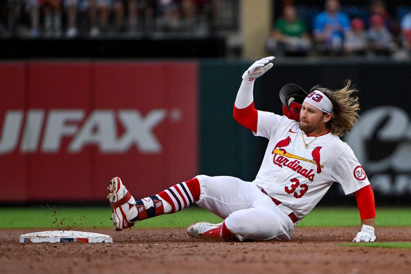Aug 8, 2024; St. Louis, Missouri, USA;  St. Louis Cardinals left fielder Brendan Donovan (33) slides in at second after hitting a one run double against the Tampa Bay Rays during the first inning at Busch Stadium. Mandatory Credit: Jeff Curry-USA TODAY Sports