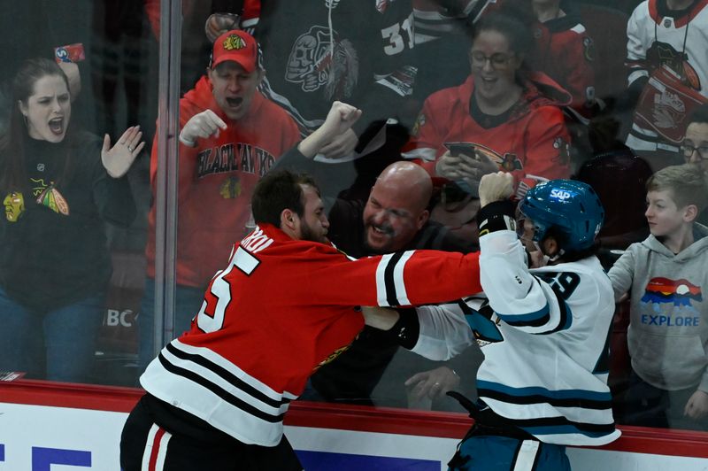 Jan 16, 2024; Chicago, Illinois, USA; San Jose Sharks right wing Scott Sabourin (49) and Chicago Blackhawks defenseman Jarred Tinordi (25) fight during the second period at United Center. Mandatory Credit: Matt Marton-USA TODAY Sports