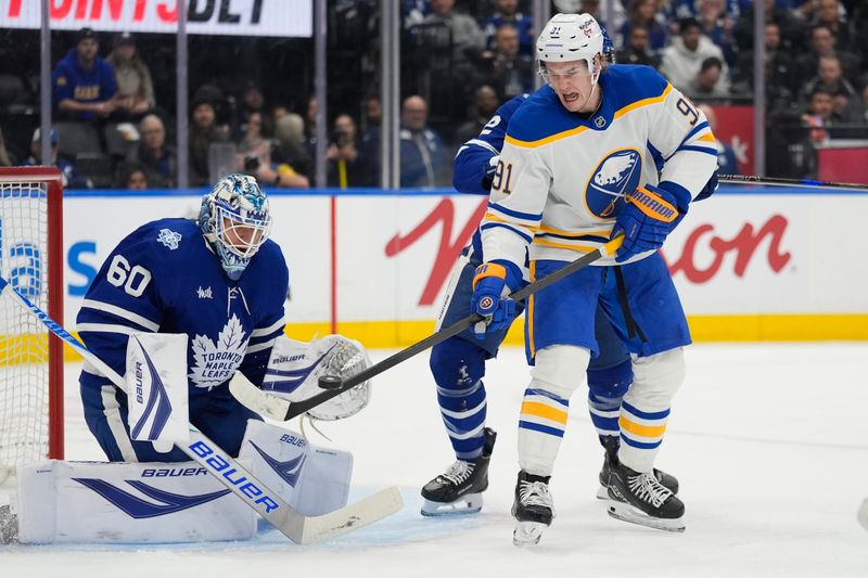 Jan 27, 2026; Toronto, Ontario, CAN; Buffalo Sabres forward Josh Doan (91) tries to deflect the puck past Toronto Maple Leafs goaltender Joseph Woll (60) during the second period at Scotiabank Arena. Mandatory Credit: John E. Sokolowski-Imagn Images