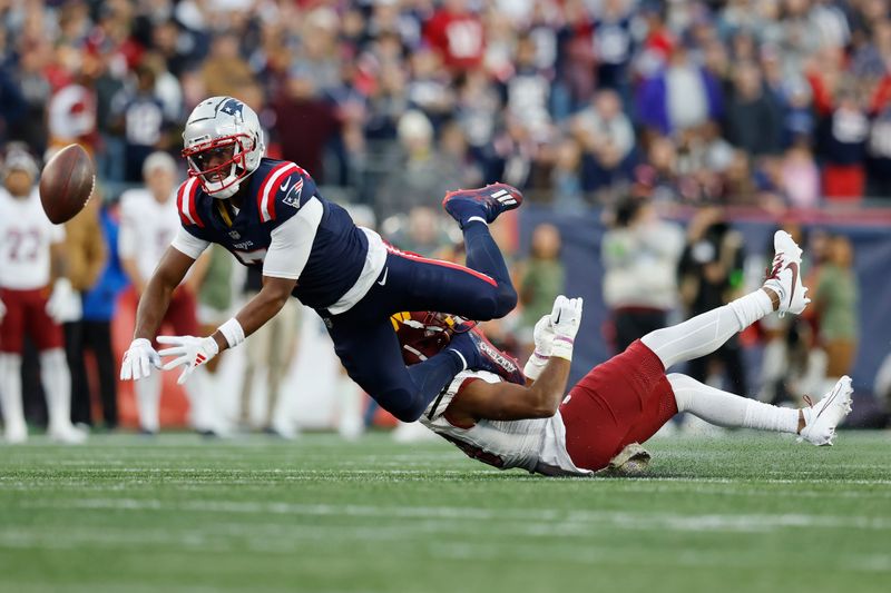 New England Patriots wide receiver JuJu Smith-Schuster (7) misses the pass reception against Washington Commanders cornerback Kendall Fuller (29) in the second half of an NFL football game, Sunday, Nov. 5, 2023, in Foxborough, Mass. (AP Photo/Michael Dwyer)