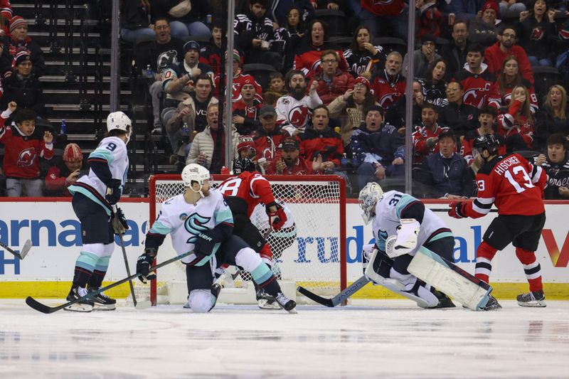 Dec 6, 2024; Newark, New Jersey, USA; New Jersey Devils right wing Timo Meier (28) scores a goal on Seattle Kraken goaltender Philipp Grubauer (31) during the third period at Prudential Center. Mandatory Credit: Ed Mulholland-Imagn Images