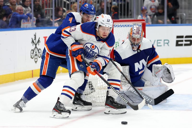 Dec 19, 2023; Elmont, New York, USA; Edmonton Oilers center Mattias Janmark (13) controls the puck against New York Islanders defenseman Samuel Bolduc (4) and goaltender Ilya Sorokin (30) during the first period at UBS Arena. Mandatory Credit: Brad Penner-USA TODAY Sports