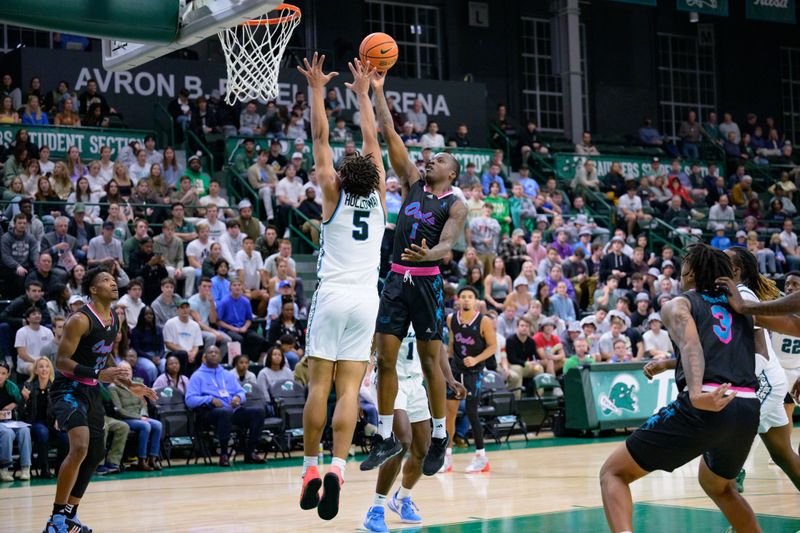 Jan 11, 2024; New Orleans, Louisiana, USA; Florida Atlantic Owls guard Johnell Davis (1) shoots against Tulane Green Wave forward Collin Holloway (5) during the first half at Avron B. Fogelman Arena in Devlin Fieldhouse. Mandatory Credit: Matthew Hinton-USA TODAY Sports