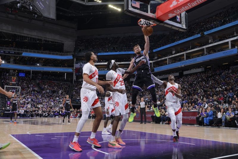 SACRAMENTO, CA - JANUARY 5: Domantas Sabonis #10 of the Sacramento Kings dunks the ball during the game against the Toronto Raptors on January 5, 2024 at Golden 1 Center in Sacramento, California. NOTE TO USER: User expressly acknowledges and agrees that, by downloading and or using this Photograph, user is consenting to the terms and conditions of the Getty Images License Agreement. Mandatory Copyright Notice: Copyright 2024 NBAE (Photo by Rocky Widner/NBAE via Getty Images)