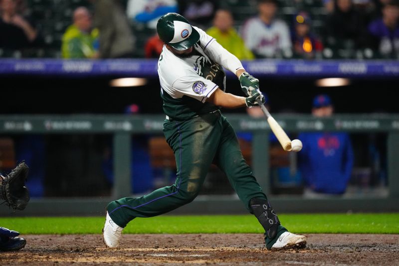 May 27, 2023; Denver, Colorado, USA; Colorado Rockies catcher Elias Diaz (35) hits a RBI single against the New York Mets in the eighth inning at Coors Field. Mandatory Credit: Ron Chenoy-USA TODAY Sports