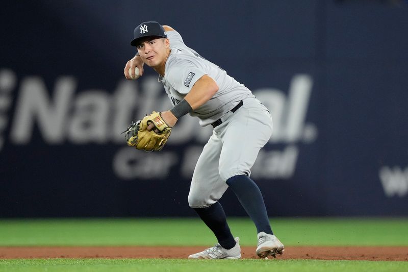 Apr 16, 2024; Toronto, Ontario, CAN; New York Yankees shortstop Anthony Volpe (11) throws out Toronto Blue Jays third baseman Ernie Clement (not pictured) at first base during the seventh inning at Rogers Centre. Mandatory Credit: John E. Sokolowski-USA TODAY Sports