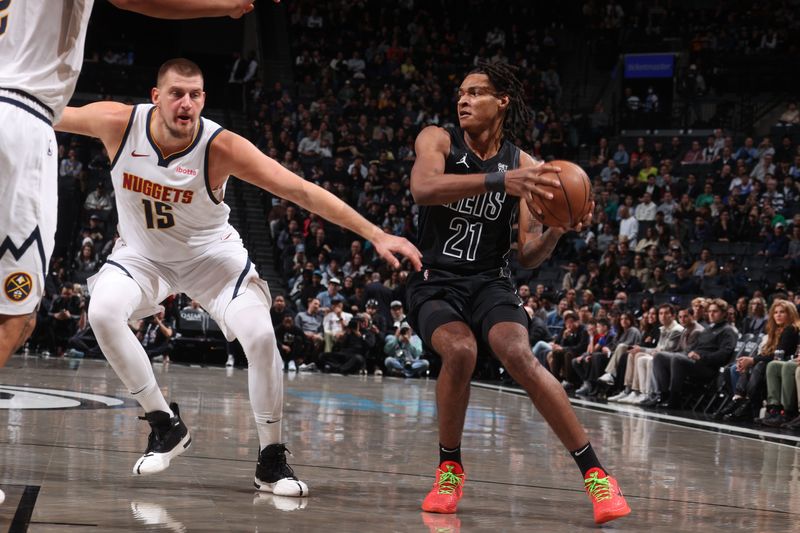 BROOKLYN, NY - OCTOBER 29: Noah Clowney #21 of the Brooklyn Nets handles the ball during the game against the Denver Nuggets on October 29, 2024 at Barclays Center in Brooklyn, New York. NOTE TO USER: User expressly acknowledges and agrees that, by downloading and or using this Photograph, user is consenting to the terms and conditions of the Getty Images License Agreement. Mandatory Copyright Notice: Copyright 2024 NBAE (Photo by Nathaniel S. Butler/NBAE via Getty Images)