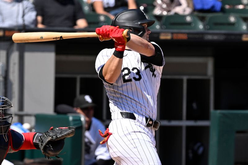 May 15, 2024; Chicago, Illinois, USA; Chicago White Sox outfielder Andrew Benintendi (23) hits a double against the Washington Nationals during the sixth inning at Guaranteed Rate Field. Mandatory Credit: Matt Marton-USA TODAY Sports