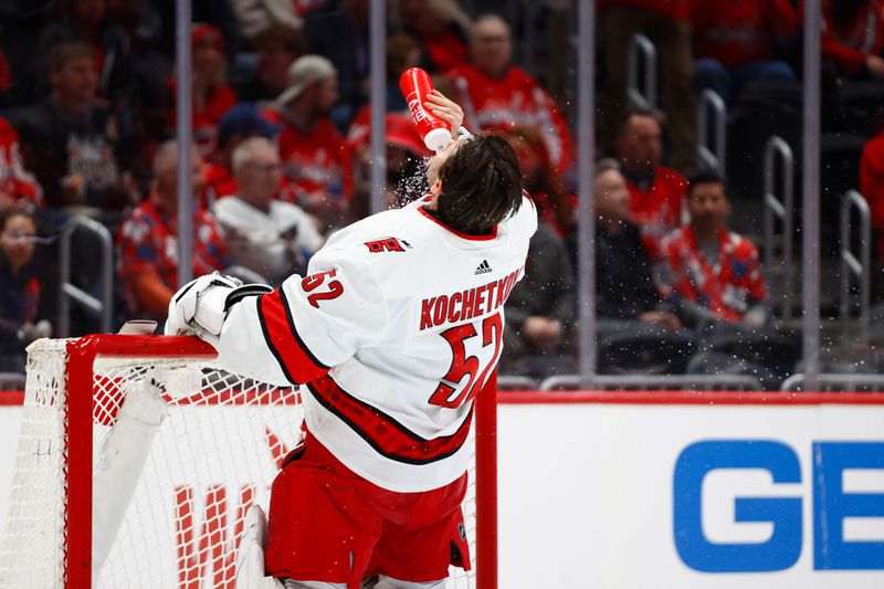 Mar 22, 2024; Washington, District of Columbia, USA; Carolina Hurricanes goaltender Pyotr Kochetkov (52) sprays himself with water prior to the first period against the Washington Capitals  at Capital One Arena. Mandatory Credit: Amber Searls-USA TODAY Sports