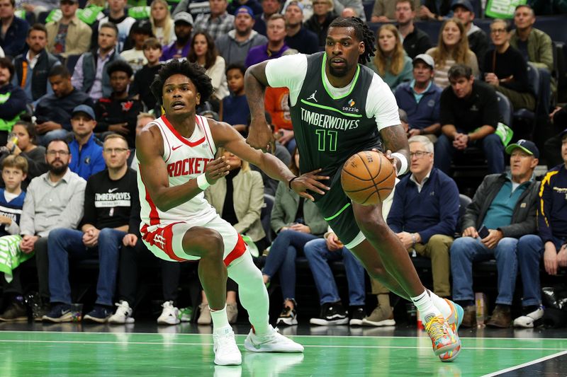 MINNEAPOLIS, MINNESOTA - NOVEMBER 26: Naz Reid #11 of the Minnesota Timberwolves drives to the basket against Amen Thompson #1 of the Houston Rockets in the first quarter during the Emirates NBA Cup at Target Center on November 26, 2024 in Minneapolis, Minnesota. NOTE TO USER: User expressly acknowledges and agrees that, by downloading and or using this photograph, User is consenting to the terms and conditions of the Getty Images License Agreement. (Photo by David Berding/Getty Images)