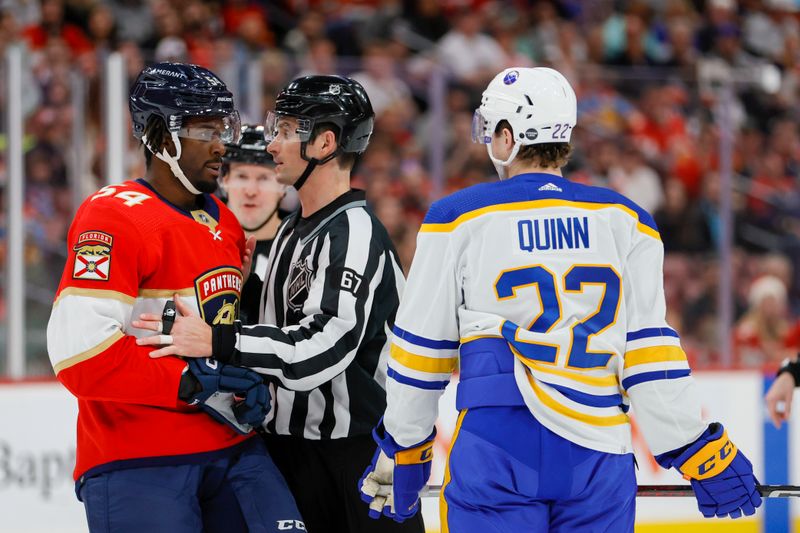 Apr 4, 2023; Sunrise, Florida, USA; Linesman Travis Gawryletz (67) separates Florida Panthers right wing Givani Smith (54) and Buffalo Sabres right wing Jack Quinn (22) during the second period at FLA Live Arena. Mandatory Credit: Sam Navarro-USA TODAY Sports