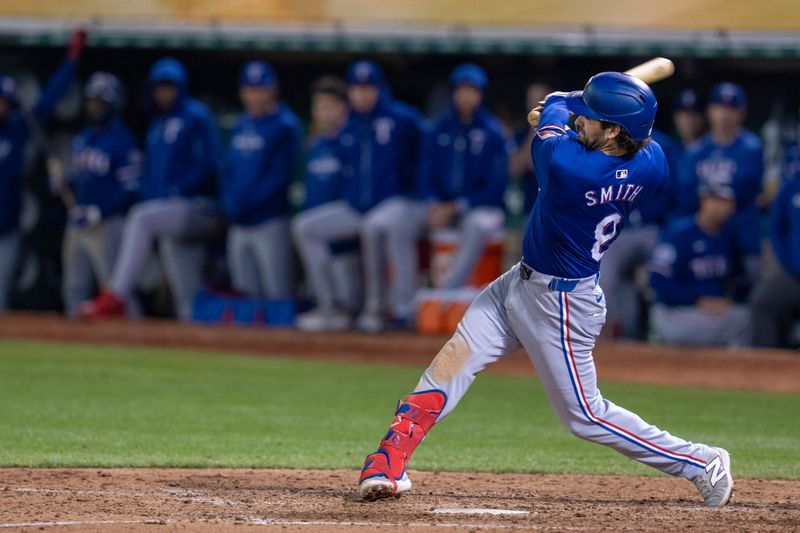 Sep 24, 2024; Oakland, California, USA; Texas Rangers shortstop Josh Smith (8) singles against the Oakland Athletics during the ninth inning at Oakland-Alameda County Coliseum. Mandatory Credit: Neville E. Guard-Imagn Images