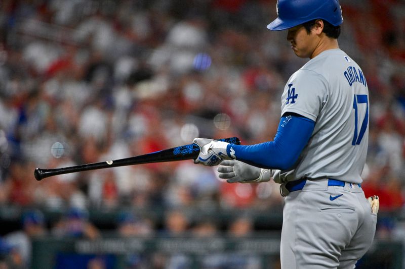 Aug 16, 2024; St. Louis, Missouri, USA;  Los Angeles Dodgers designated hitter Shohei Ohtani (17) checks his bat during the ninth inning against the St. Louis Cardinals at Busch Stadium. Mandatory Credit: Jeff Curry-USA TODAY Sports