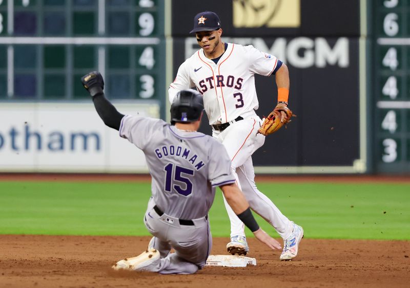 Jun 25, 2024; Houston, Texas, USA; Houston Astros shortstop Jeremy Pena (3) forces out Colorado Rockies catcher Hunter Goodman (15) at second base in the seventh inning at Minute Maid Park. Mandatory Credit: Thomas Shea-USA TODAY Sports