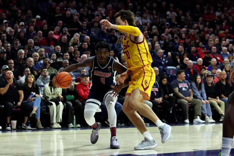 Jan 17, 2024; Tucson, Arizona, USA; Arizona Wildcats guard Jaden Bradley (0) drives to the net against USC Trojans forward Harrison Hornery (30) during the second half at McKale Center. Mandatory Credit: Zachary BonDurant-USA TODAY Sports