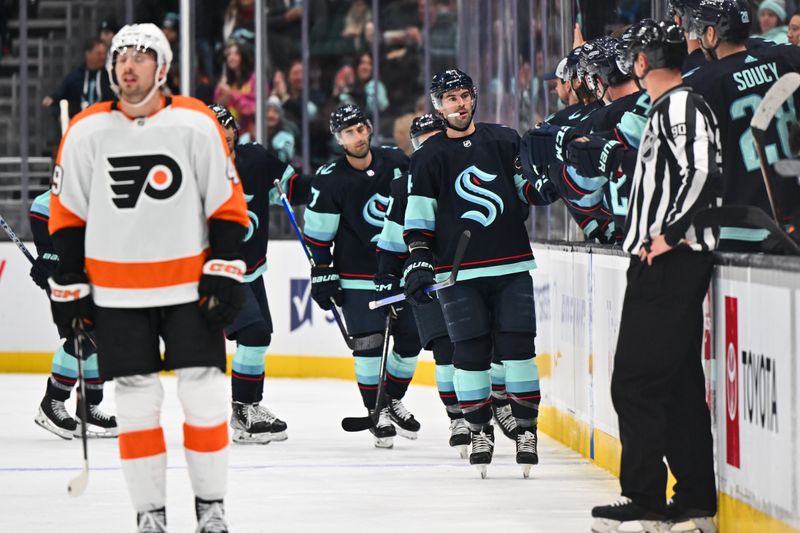 Feb 16, 2023; Seattle, Washington, USA; Seattle Kraken defenseman Justin Schultz (4) celebrates with the bench after scoring a goal against the Philadelphia Flyers during the second period at Climate Pledge Arena. Mandatory Credit: Steven Bisig-USA TODAY Sports