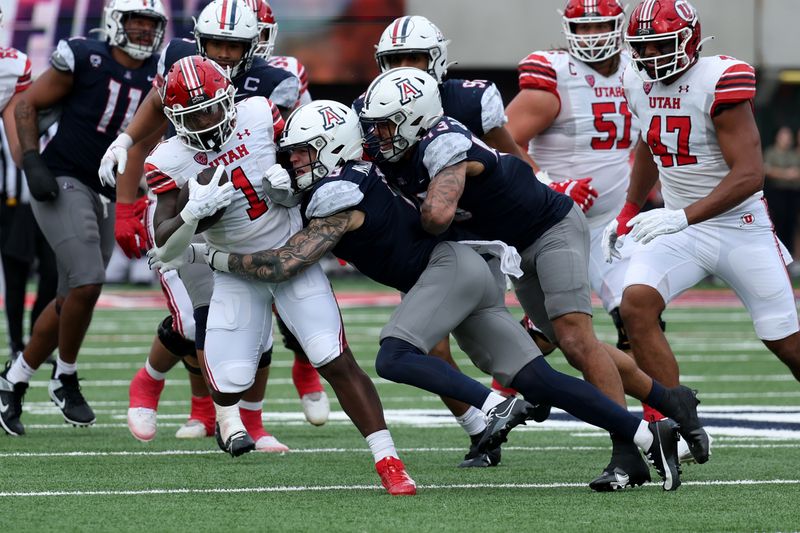 Nov 18, 2023; Tucson, Arizona, USA; Arizona Wildcats safety Gunner Maldonado (9) tackles Utah Utes running back Jaylon Glover (1) during the second half at Arizona Stadium. Mandatory Credit: Zachary BonDurant-USA TODAY Sports