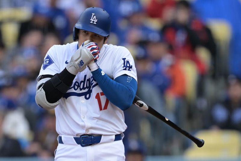 Apr 14, 2024; Los Angeles, California, USA; Los Angeles Dodgers designated hitter Shohei Ohtani (17) blows into his hands during his at bat in the first inning against the San Diego Padres at Dodger Stadium. Mandatory Credit: Jayne Kamin-Oncea-USA TODAY Sports