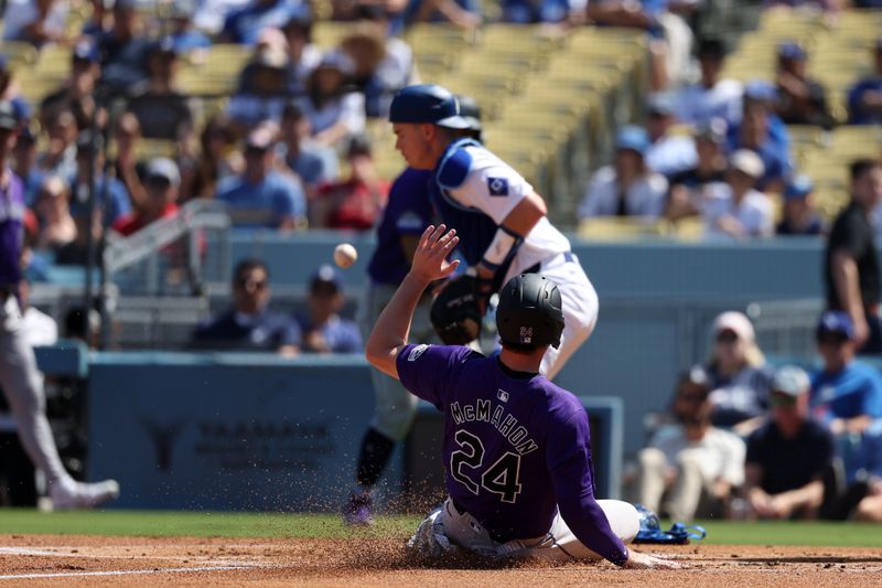 Sep 22, 2024; Los Angeles, California, USA;  Colorado Rockies third baseman Ryan McMahon (24) scores a run while Los Angeles Dodgers catcher Will Smith (16) bobbles a ball during the first inning at Dodger Stadium. Mandatory Credit: Kiyoshi Mio-Imagn Images