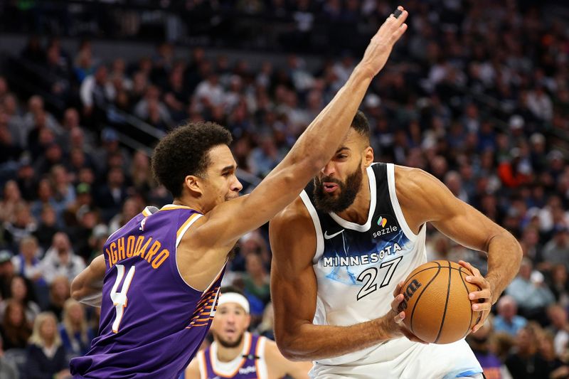 MINNEAPOLIS, MINNESOTA - NOVEMBER 17: Rudy Gobert #27 of the Minnesota Timberwolves goes to the basket against Oso Ighodaro #4 of the Phoenix Suns in the second quarter of the game at Target Center on November 17, 2024 in Minneapolis, Minnesota. NOTE TO USER: User expressly acknowledges and agrees that, by downloading and or using this photograph, User is consenting to the terms and conditions of the Getty Images License Agreement. (Photo by David Berding/Getty Images)