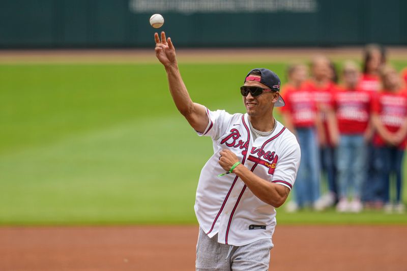 May 21, 2023; Cumberland, Georgia, USA; Atlanta Falcons quarterback Desmond Ridder throws out the opening pitch prior to the game between the Seattle Mariners and the Atlanta Braves at Truist Park. Mandatory Credit: Dale Zanine-USA TODAY Sports