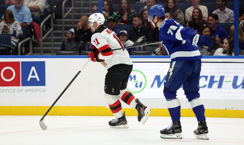 Nov 18, 2025; Tampa, Florida, USA; New Jersey Devils right wing Stefan Noesen (11) holds Tampa Bay Lightning defenseman Emil Lilleberg (78) stick during the second period at Benchmark International Arena. Mandatory Credit: Kim Klement Neitzel-Imagn Images