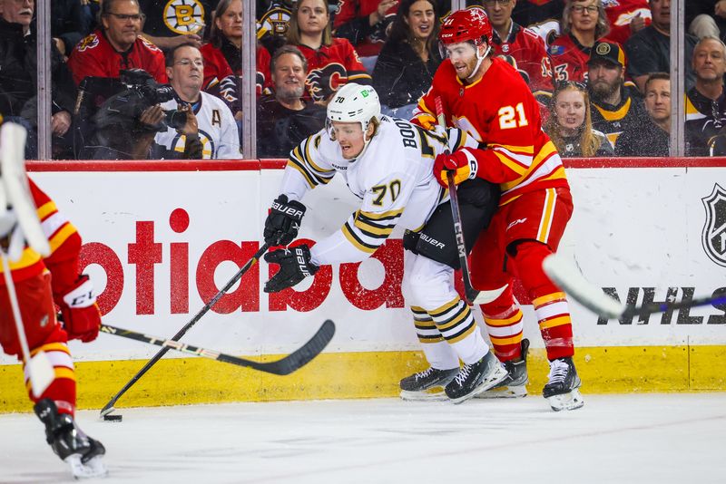 Feb 22, 2024; Calgary, Alberta, CAN; Boston Bruins goaltender Brandon Bussi (70) and Calgary Flames center Kevin Rooney (21) battles for the puck during the first period at Scotiabank Saddledome. Mandatory Credit: Sergei Belski-USA TODAY Sports