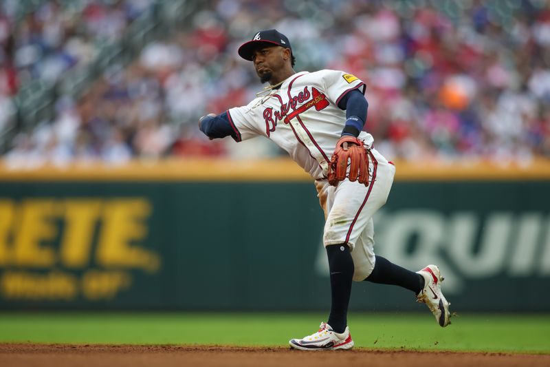Sep 30, 2024; Atlanta, Georgia, USA; Atlanta Braves second baseman Ozzie Albies (1) throws a runner out at first against the New York Mets in the sixth inning at Truist Park. Mandatory Credit: Brett Davis-Imagn Images
