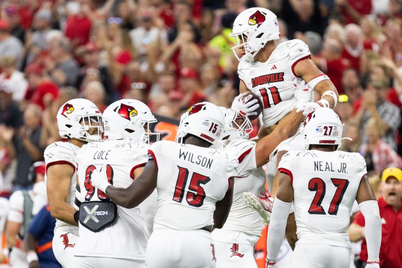 Sep 16, 2023; Indianapolis, Indiana, USA; Louisville Cardinals defensive back Cam'Ron Kelly (11) celebrates with teammates after making an interception against the Indiana Hoosiers in the first quarter at Lucas Oil Stadium. Mandatory Credit: Trevor Ruszkowski-USA TODAY Sports