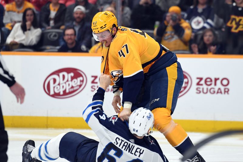 Apr 9, 2024; Nashville, Tennessee, USA; Nashville Predators right wing Michael McCarron (47) hits Winnipeg Jets defenseman Logan Stanley (64) during a fight in the third period at Bridgestone Arena. Mandatory Credit: Christopher Hanewinckel-USA TODAY Sports