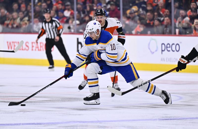 Nov 1, 2023; Philadelphia, Pennsylvania, USA; Buffalo Sabres defenseman Henri Jokiharju (10) reaches for the puck against the Philadelphia Flyers in the second period at Wells Fargo Center. Mandatory Credit: Kyle Ross-USA TODAY Sports