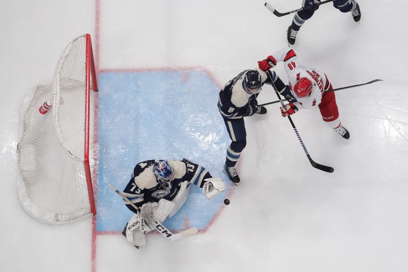 Apr 16, 2024; Columbus, Ohio, USA; Columbus Blue Jackets goalie Jet Greaves (73) makes a save as Carolina Hurricanes left wing Jordan Martinook (48) looks for a rebound during the third period at Nationwide Arena. Mandatory Credit: Russell LaBounty-USA TODAY Sports