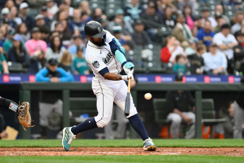 Jun 14, 2023; Seattle, Washington, USA; Seattle Mariners right fielder Teoscar Hernandez (35) hits a double against the Miami Marlins during the fourth inning at T-Mobile Park. Mandatory Credit: Steven Bisig-USA TODAY Sports