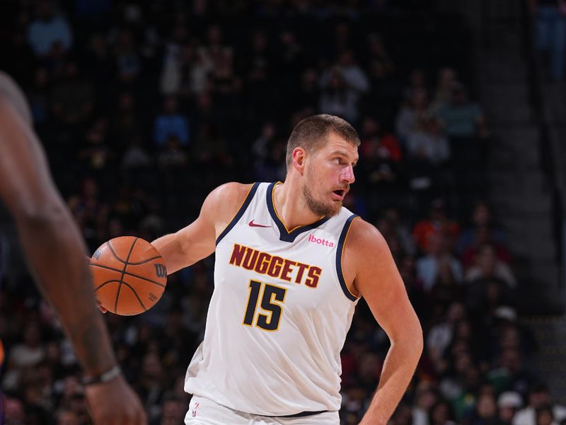 DENVER, CO - OCTOBER 13: Nikola Jokic #15 of the Denver Nuggets dribbles the ball during the game against the Phoenix Suns on October 13, 2024 at Ball Arena in Denver, Colorado. NOTE TO USER: User expressly acknowledges and agrees that, by downloading and/or using this Photograph, user is consenting to the terms and conditions of the Getty Images License Agreement. Mandatory Copyright Notice: Copyright 2024 NBAE (Photo by Bart Young/NBAE via Getty Images)