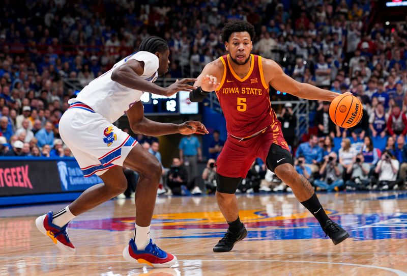 Jan 13, 2026; Lawrence, Kansas, USA; Iowa State Cyclones forward Joshua Jefferson (5) drives against Kansas Jayhawks forward Flory Bidunga (40) during the first half at Allen Fieldhouse. Mandatory Credit: Jay Biggerstaff-Imagn Images