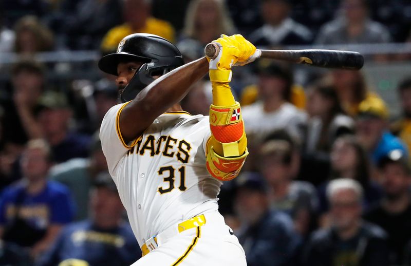 Sep 25, 2024; Pittsburgh, Pennsylvania, USA;  Pittsburgh Pirates shortstop  Liover Peguero (31) hits a two-run double against the Milwaukee Brewers during the fifth inning at PNC Park. Mandatory Credit: Charles LeClaire-Imagn Images