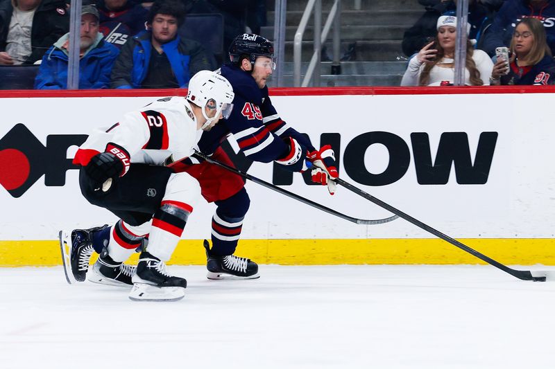 Dec 15, 2025; Winnipeg, Manitoba, CAN;  Winnipeg Jets forward Cole Koepke (45) tries to skates away from Ottawa Senators defenseman Artem Zub (2) during the second period at Canada Life Centre. Mandatory Credit: Terrence Lee-Imagn Images