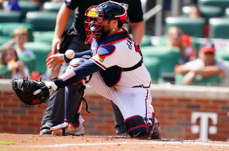 Sep 10, 2023; Cumberland, Georgia, USA; Atlanta Braves catcher Travis d'Arnaud (16) bobbles the throw to home plate as Pittsburgh Pirates second baseman Ji Hwan Bae (3) slides safely into home for a run during the sixth inning at Truist Park. Mandatory Credit: John David Mercer-USA TODAY Sports