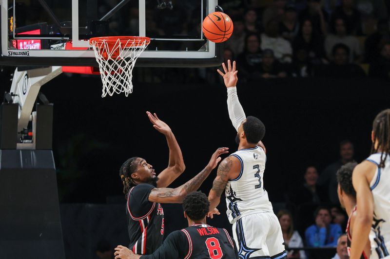 Jan 18, 2025; Orlando, Florida, USA; UCF Knights guard Darius Johnson (3) goes to the basket against Houston Cougars forward Ja'Vier Francis (5) during the second half at Addition Financial Arena. Mandatory Credit: Mike Watters-Imagn Images