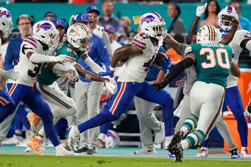 Buffalo Bills cornerback Christian Benford (47) runs after intercepting a pass during the first half of an NFL football game against the Miami Dolphins, Thursday, Sept. 12, 2024, in Miami Gardens, Fla. (AP Photo/Rebecca Blackwell)