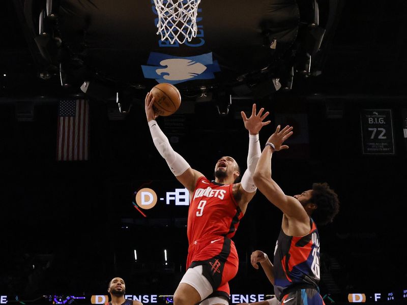 NEW YORK, NEW YORK - JANUARY 27:  Dillon Brooks #9 of the Houston Rockets dunks against Spencer Dinwiddie #26 of the Brooklyn Nets  during their game at Barclays Center on January 27, 2024 in New York City.  User expressly acknowledges and agrees that, by downloading and or using this photograph, User is consenting to the terms and conditions of the Getty Images License Agreement.   (Photo by Al Bello/Getty Images)