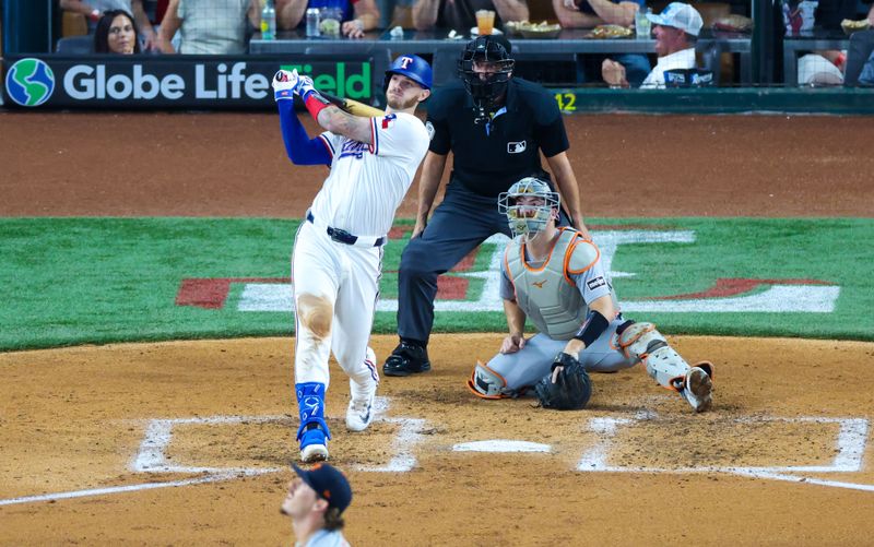 Jun 5, 2024; Arlington, Texas, USA;  Texas Rangers catcher Jonah Heim (28) hits a two-run home run during the third inning against the Detroit Tigers at Globe Life Field. Mandatory Credit: Kevin Jairaj-USA TODAY Sports
