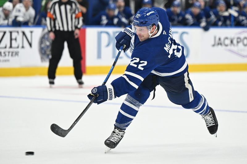 Mar 7, 2026; Toronto, Ontario, CAN;  Toronto Maple Leafs defenseman Jake McCabe (22) hits a slapshot against the Tampa Bay Lightning in the third period at Scotiabank Arena. Mandatory Credit: Dan Hamilton-Imagn Images