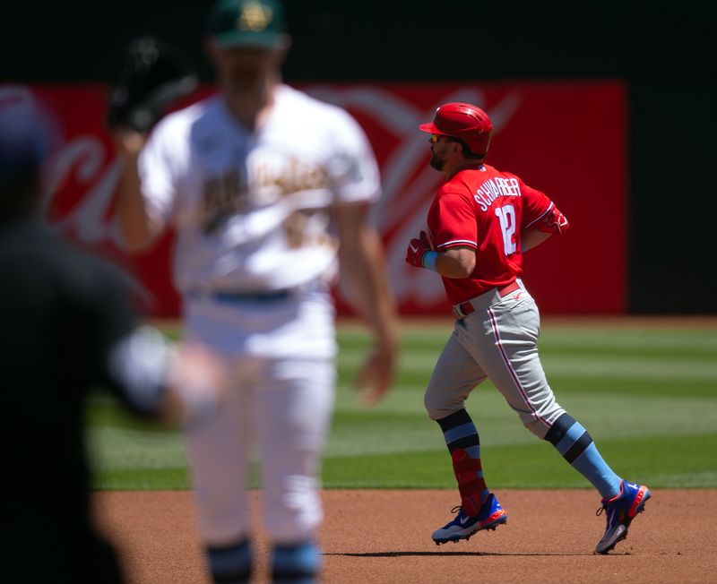 Jun 18, 2023; Oakland, California, USA; Philadelphia Phillies designated hitter Kyle Schwarber (12) runs out his solo home run off Oakland Athletics starting pitcher Hogan Harris (63) during the first inning at Oakland-Alameda County Coliseum. Mandatory Credit: D. Ross Cameron-USA TODAY Sports