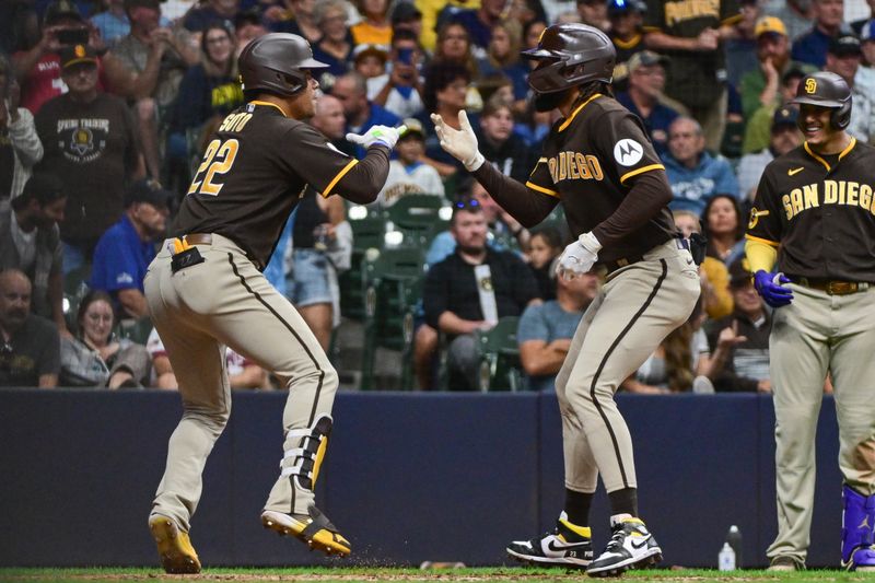 Aug 26, 2023; Milwaukee, Wisconsin, USA; San Diego Padres designated hitter Juan Soto (22) celebrates with right fielder Fernando Tatis (23) after hitting a two-run home run in the eighth inning against the Milwaukee Brewers at American Family Field. Mandatory Credit: Benny Sieu-USA TODAY Sports