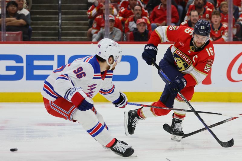 May 26, 2024; Sunrise, Florida, USA; Florida Panthers center Aleksander Barkov (16) moves the puck as New York Rangers center Jack Roslovic (96) defends during the third period in game three of the Eastern Conference Final of the 2024 Stanley Cup Playoffs at Amerant Bank Arena. Mandatory Credit: Sam Navarro-USA TODAY Sports