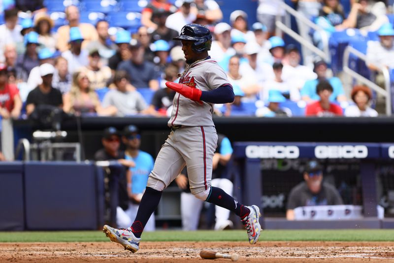 Apr 14, 2024; Miami, Florida, USA; Atlanta Braves second baseman Ozzie Albies (1) scores after an RBI single by first baseman Matt Olson (not pictured) during the third inning at loanDepot Park. Mandatory Credit: Sam Navarro-USA TODAY Sports